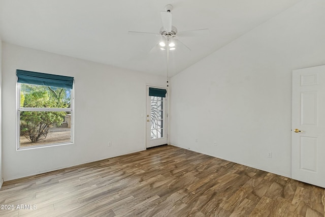 unfurnished room featuring a ceiling fan, vaulted ceiling, and wood finished floors