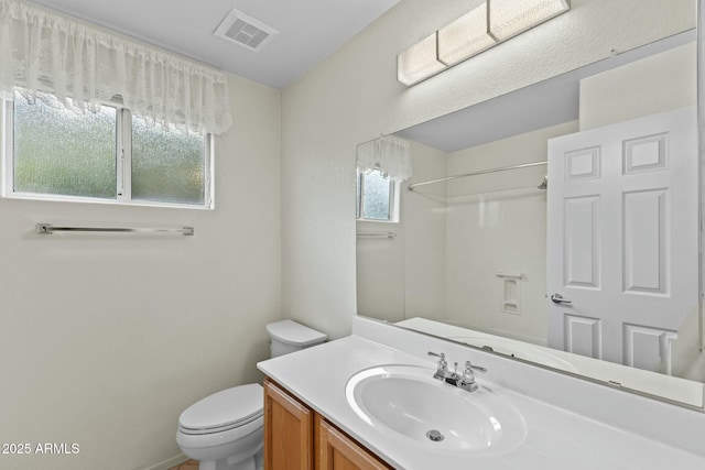 full bath with toilet, a shower, vanity, and visible vents