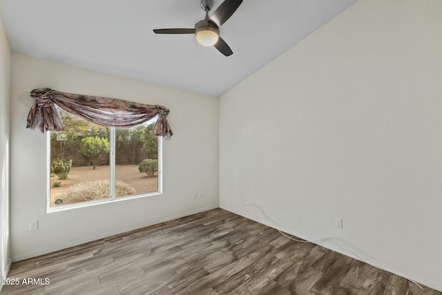 unfurnished room with ceiling fan and wood finished floors