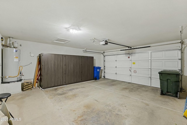 garage featuring gas water heater and a garage door opener