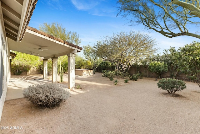 view of yard with a hot tub, a patio area, a fenced backyard, and ceiling fan