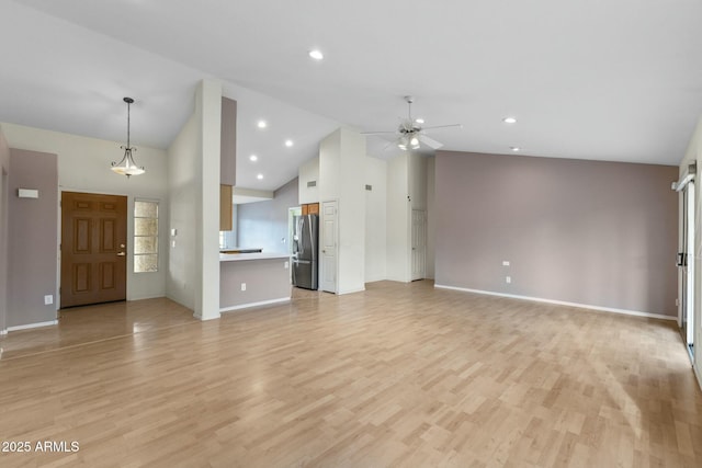 unfurnished living room featuring baseboards, high vaulted ceiling, a ceiling fan, and light wood-style floors