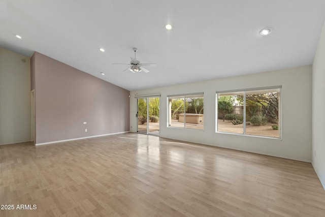 unfurnished living room with lofted ceiling, recessed lighting, light wood-style floors, a ceiling fan, and baseboards