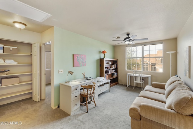 carpeted office featuring ceiling fan