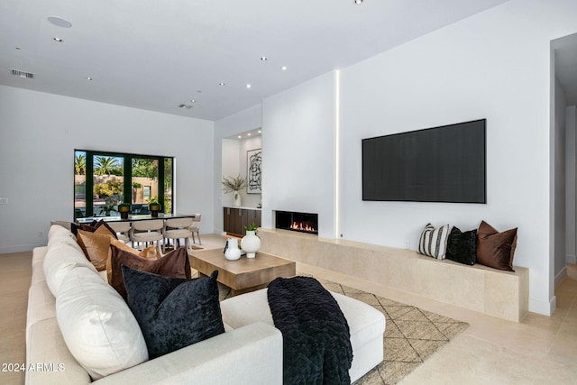 tiled living room featuring a fireplace