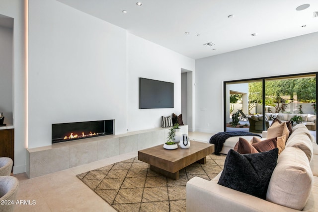 tiled living room featuring a tiled fireplace