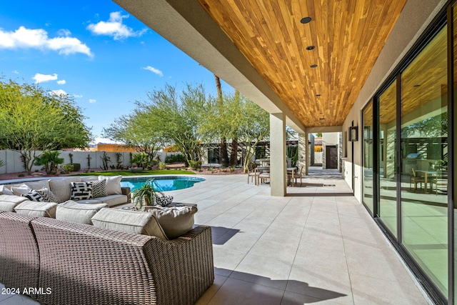 view of patio / terrace with a fenced in pool and an outdoor hangout area