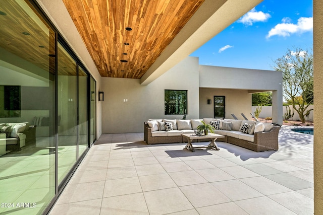 balcony with an outdoor hangout area and a patio