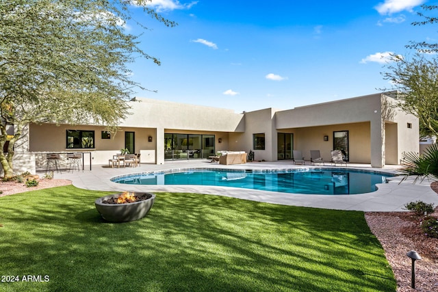 view of pool with a patio area, a yard, and an outdoor bar