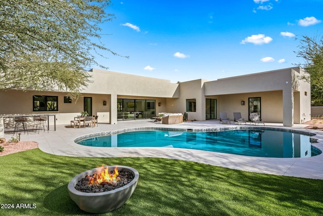 view of pool featuring a patio area and a yard