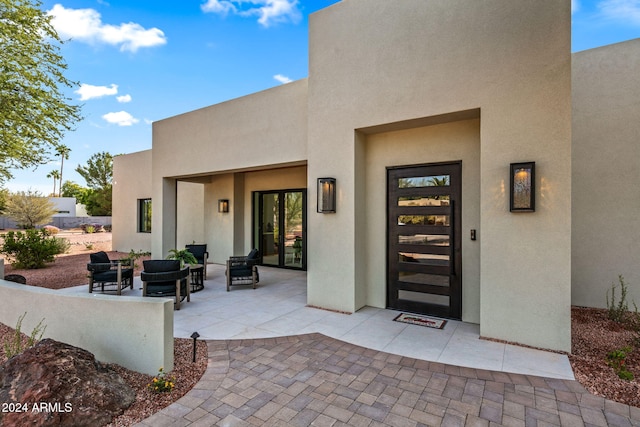 doorway to property with a patio area and an outdoor hangout area