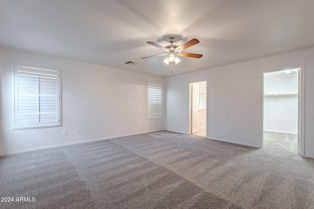 empty room featuring light carpet and ceiling fan