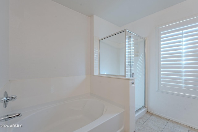 bathroom with tile patterned flooring and independent shower and bath