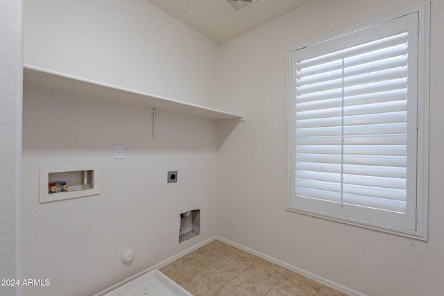 clothes washing area featuring hookup for an electric dryer, hookup for a washing machine, gas dryer hookup, and light tile patterned flooring