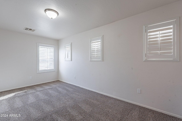 unfurnished room featuring carpet flooring