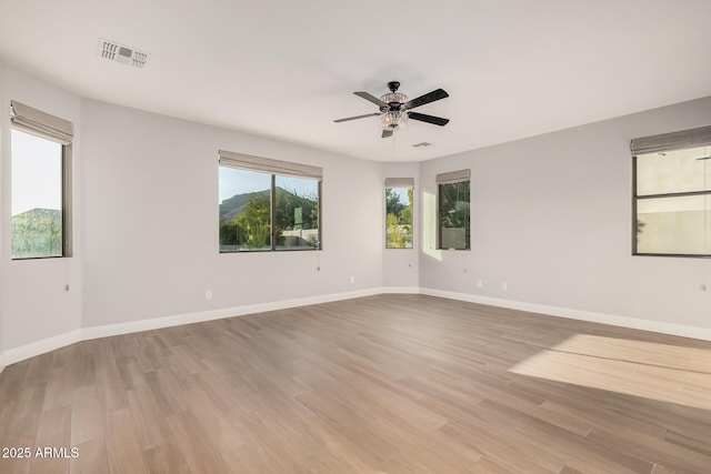 unfurnished room with ceiling fan and light wood-type flooring