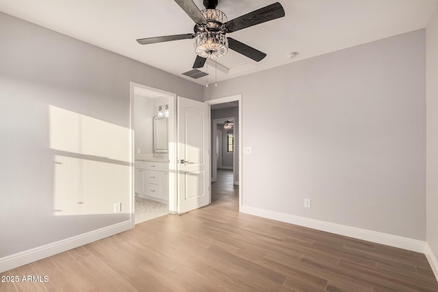 empty room with ceiling fan, sink, and hardwood / wood-style flooring