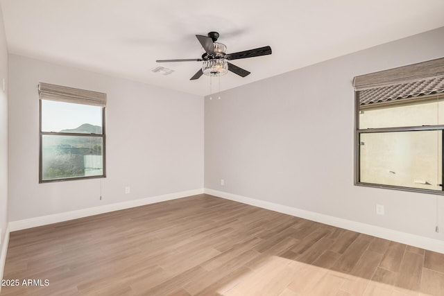 unfurnished room with ceiling fan and light hardwood / wood-style floors