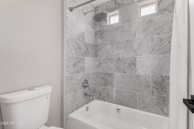 bathroom featuring shower / bath combination with curtain and toilet