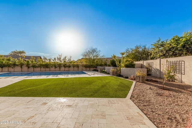 view of yard featuring a fenced in pool and a patio area