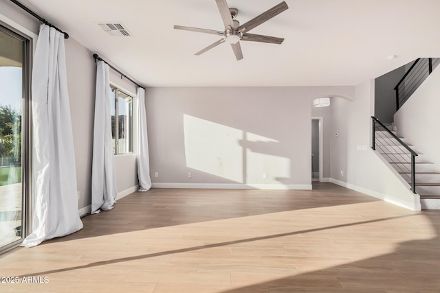 unfurnished living room with hardwood / wood-style flooring and ceiling fan