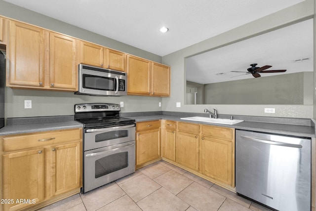 kitchen featuring appliances with stainless steel finishes, light tile patterned floors, sink, and light brown cabinets