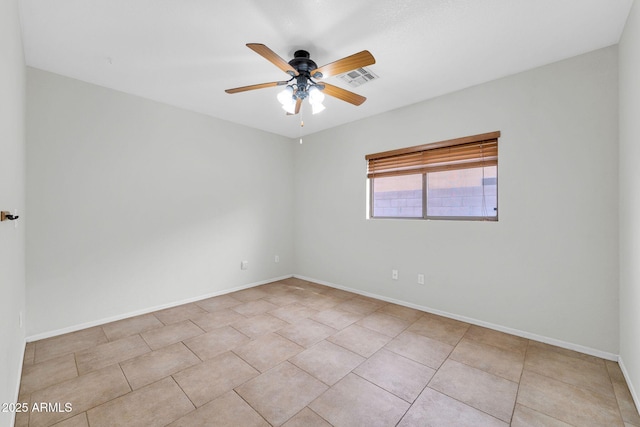 tiled empty room with ceiling fan