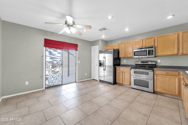 kitchen with appliances with stainless steel finishes, ceiling fan, and light tile patterned floors