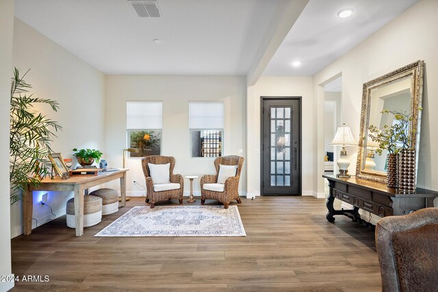 sitting room with hardwood / wood-style floors and a wealth of natural light