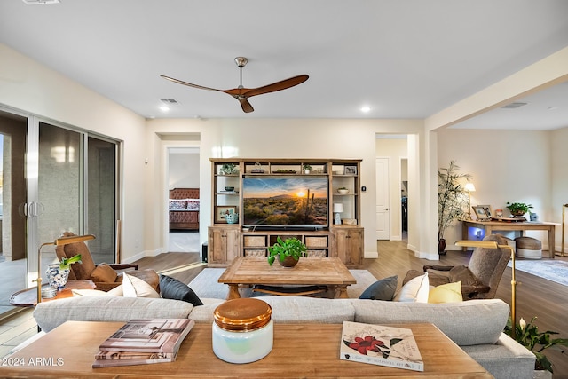 living room with hardwood / wood-style flooring and ceiling fan