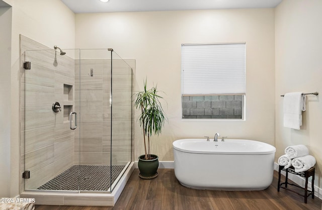 bathroom featuring independent shower and bath and hardwood / wood-style flooring