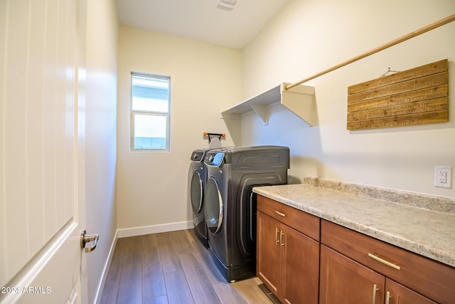 clothes washing area with light hardwood / wood-style floors and independent washer and dryer