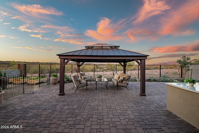 patio terrace at dusk with a gazebo and an outdoor living space