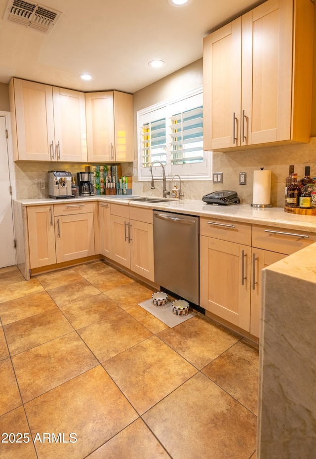 kitchen featuring dishwasher, sink, light tile patterned floors, and backsplash