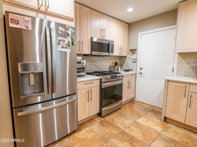 kitchen with stainless steel appliances, decorative backsplash, and light tile patterned floors