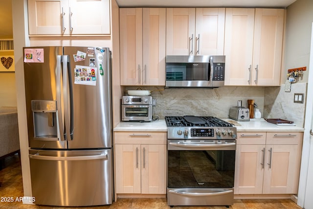 kitchen featuring light stone counters, backsplash, and stainless steel appliances