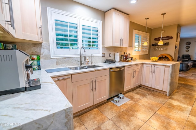 kitchen featuring dishwasher, sink, backsplash, hanging light fixtures, and kitchen peninsula