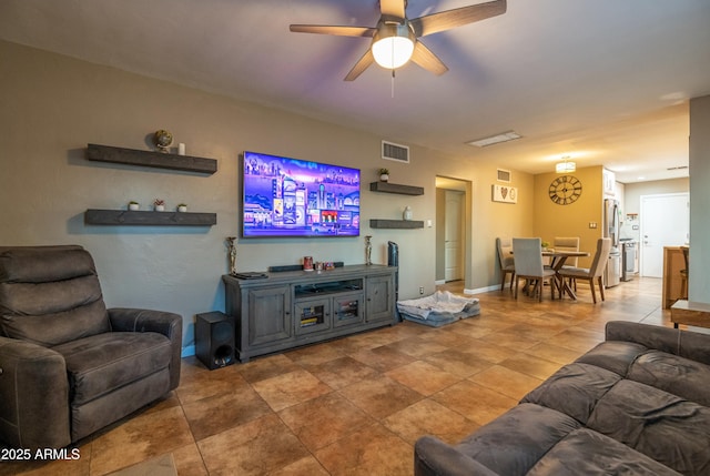 living room featuring ceiling fan and tile patterned floors