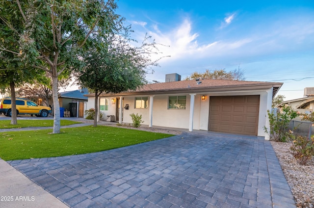 ranch-style home with a garage and a front yard