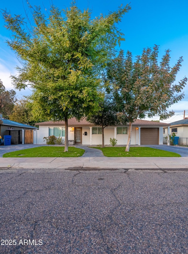 view of front of home with a garage and a front lawn