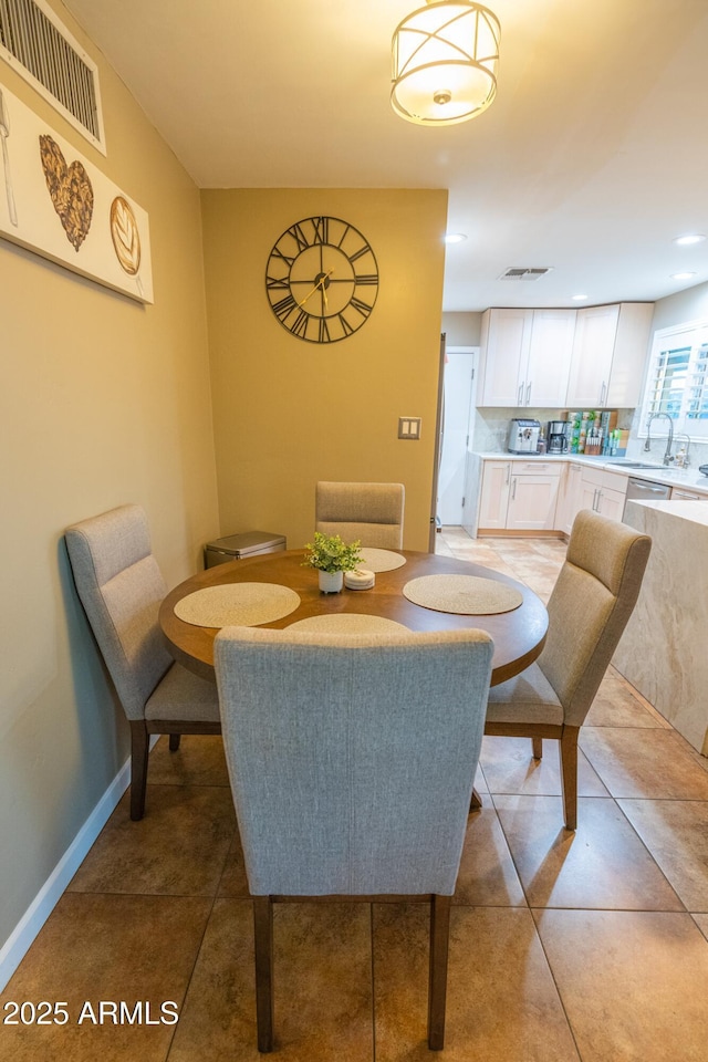 tiled dining area featuring sink