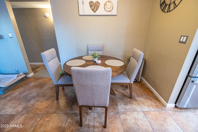 dining space featuring tile patterned floors