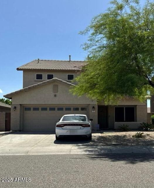 11633 W Jefferson St, Avondale, AZ 85323 - view of front of property with a tiled roof, driveway, an attached garage, and stucco siding