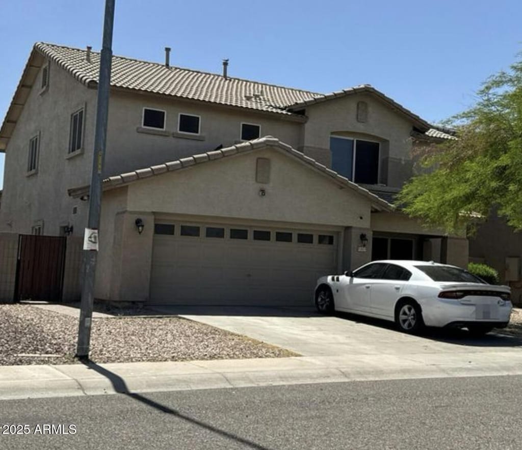 11633 W Jefferson St, Avondale, AZ 85323 - view of front of property featuring a garage, a tile roof, and stucco siding