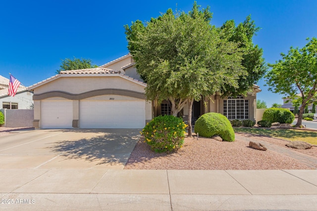 1802 W Encinas St, Gilbert, AZ 85233 - obstructed view of property with an attached garage, stucco siding, concrete driveway, and a tiled roof