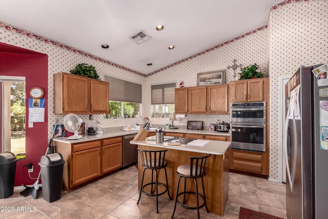 1802 W Encinas St, Gilbert, AZ 85233 - kitchen featuring appliances with stainless steel finishes, light countertops, lofted ceiling, a kitchen island, and wallpapered walls