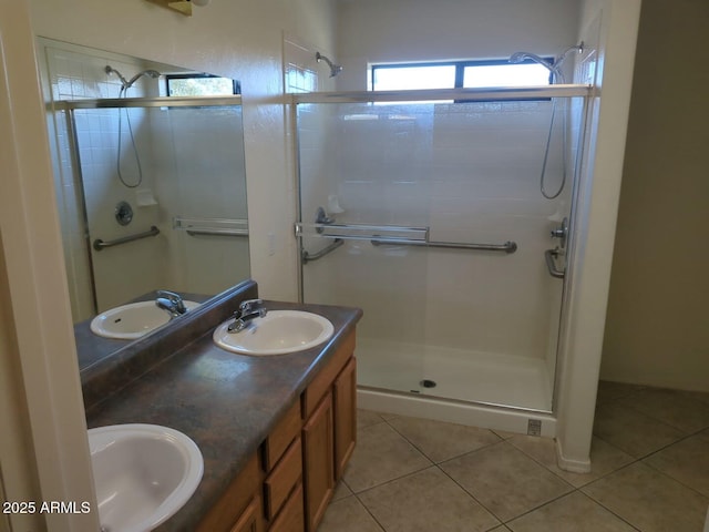 bathroom featuring tile patterned floors, a stall shower, and a sink