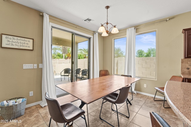 14430 W Windsor Ave, Goodyear, AZ 85395 - dining area with a chandelier, baseboards, and light tile patterned floors