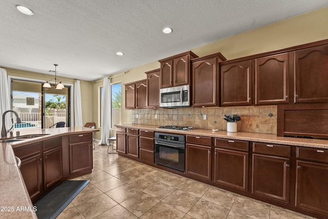 14430 W Windsor Ave, Goodyear, AZ 85395 - kitchen with appliances with stainless steel finishes, a sink, backsplash, light countertops, and decorative light fixtures