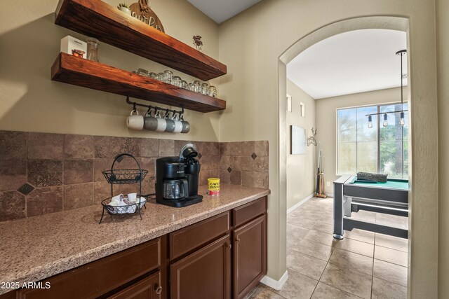 14430 W Windsor Ave, Goodyear, AZ 85395 - bar area with arched walkways, light tile patterned floors, backsplash, and baseboards